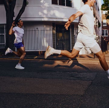 two individuals running on an urban street two individuals running on an urban street