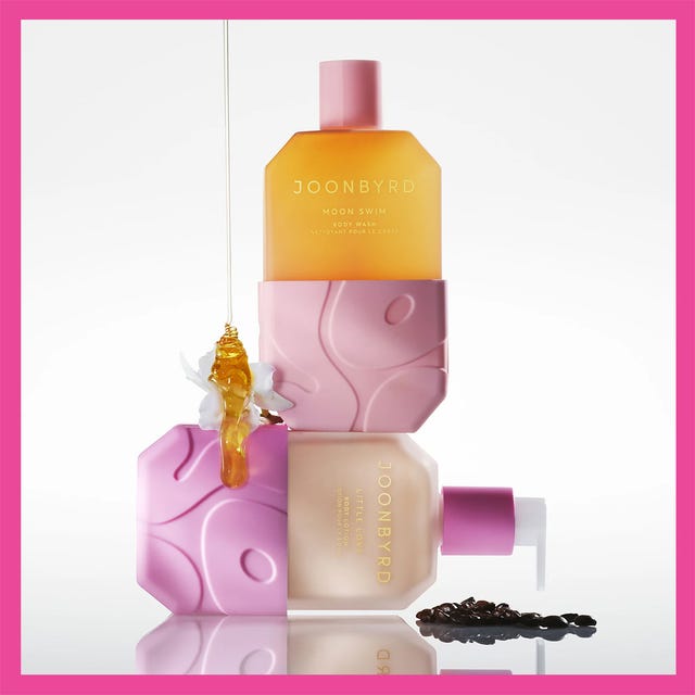 Three Joonbyrd body wash bottles with pink and amber packaging against contrasting backgrounds.