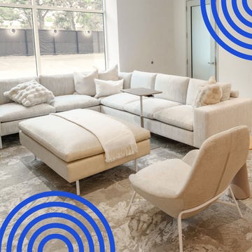 Modern lounge area with a sectional sofa and tables, featuring a stylish aesthetic and warm lighting for relaxation.