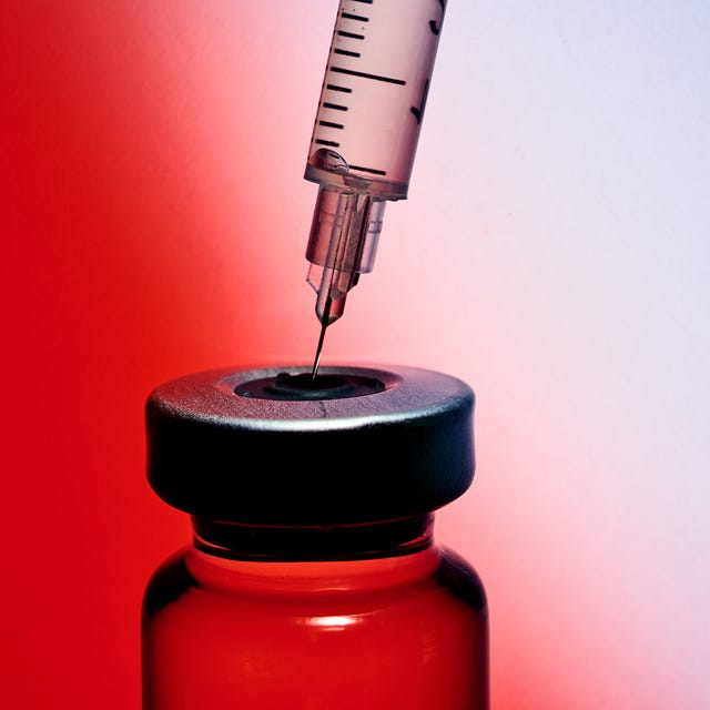 Syringe poised over a vial, ready for filling, against a gradient red and white background.