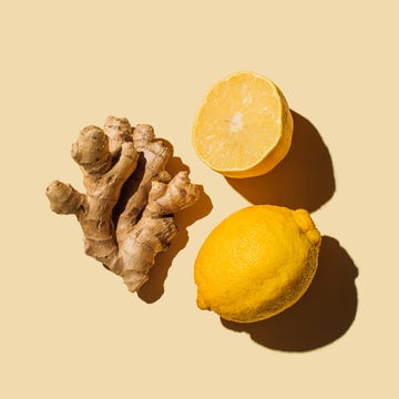 Fresh ginger with lemon on beige background. Flat lay, top view, copy space. Fresh ginger with lemon on beige background. Flat lay, top view, copy space.