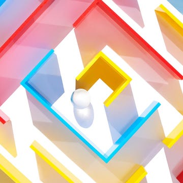 Colorful maze structure with a white ball in the center.