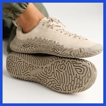 A pair of stylish athletic shoes showcasing unique designs and textures, with one shoe in cream and the other in darker tones.