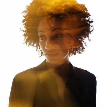 silhouette of a person with curly hair against a bright background featuring dramatic lighting