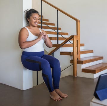 3 moves for busy mums: woman doing a wall sit at home