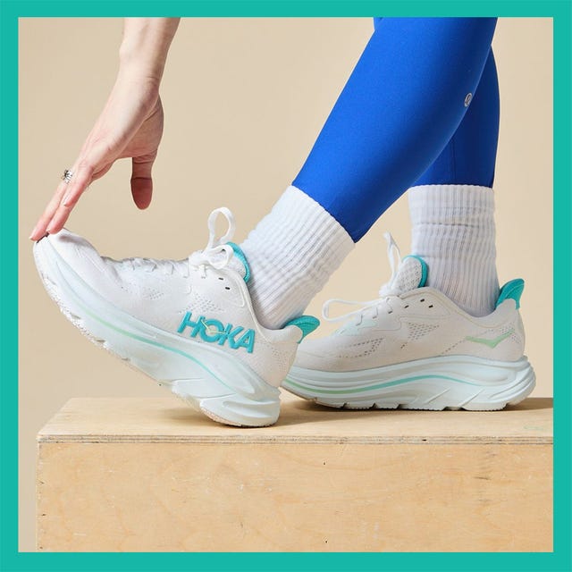 Two pairs of athletic shoes: a pink Nike pair and a white Hoka pair worn by a person with blue leggings.