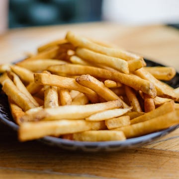 close up of large plate of french fries at restaurant
