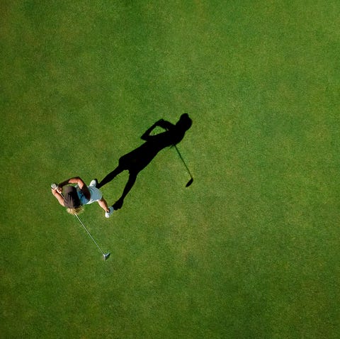 woman playing golf on golf course
