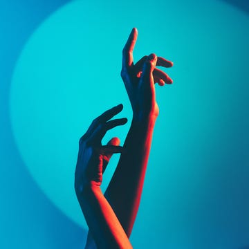 Colorful hands reaching upward against a gradient background of blue and teal tones. Colorful hands reaching upward against a gradient background of blue and teal tones.