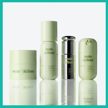 Skincare products alongside a blurred image of a face. Skincare products alongside a blurred image of a face.
