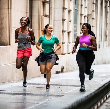 Group of women running through urban area group of women running through urban area