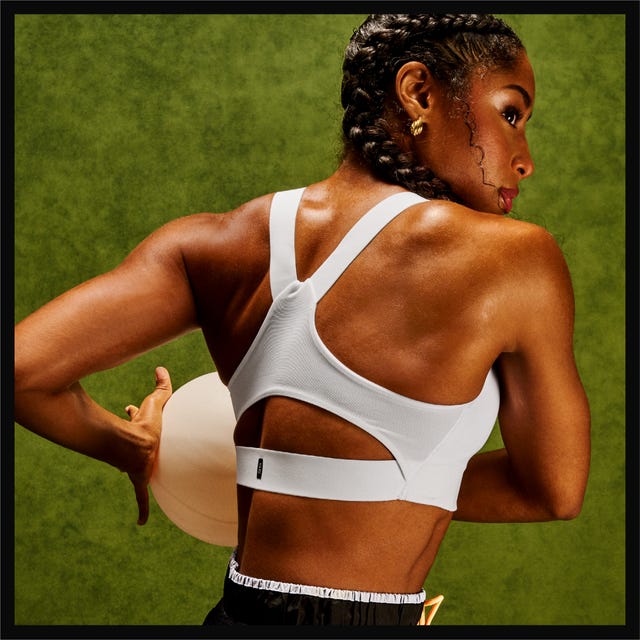 Athlete in a sports bra holding a volleyball. Athlete in a sports bra holding a volleyball.