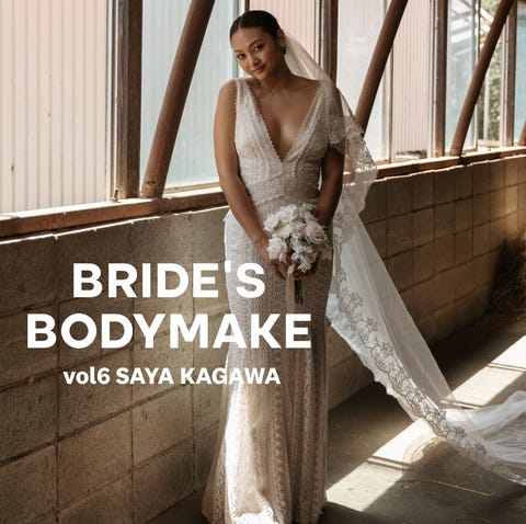 bride in lace dress, holding bouquet, smiling outdoors