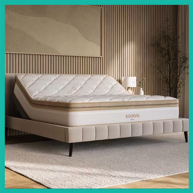 Luxury mattress displayed on a plush bed frame in a modern bedroom setting, showcasing the mattress's detailed design.