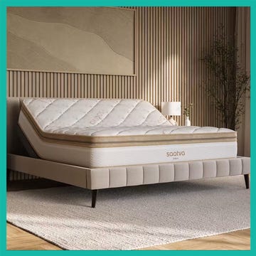 Luxury mattress displayed on a plush bed frame in a modern bedroom setting, showcasing the mattress's detailed design.