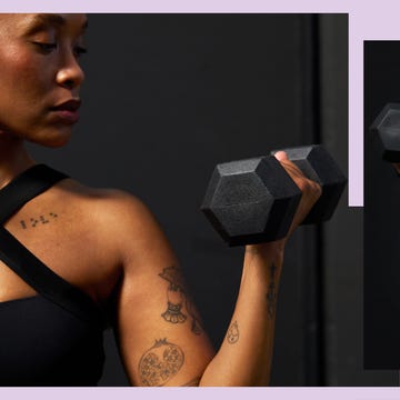 A person lifting a hexagonal dumbbell, showcasing tattoos and athletic wear against a dark background.