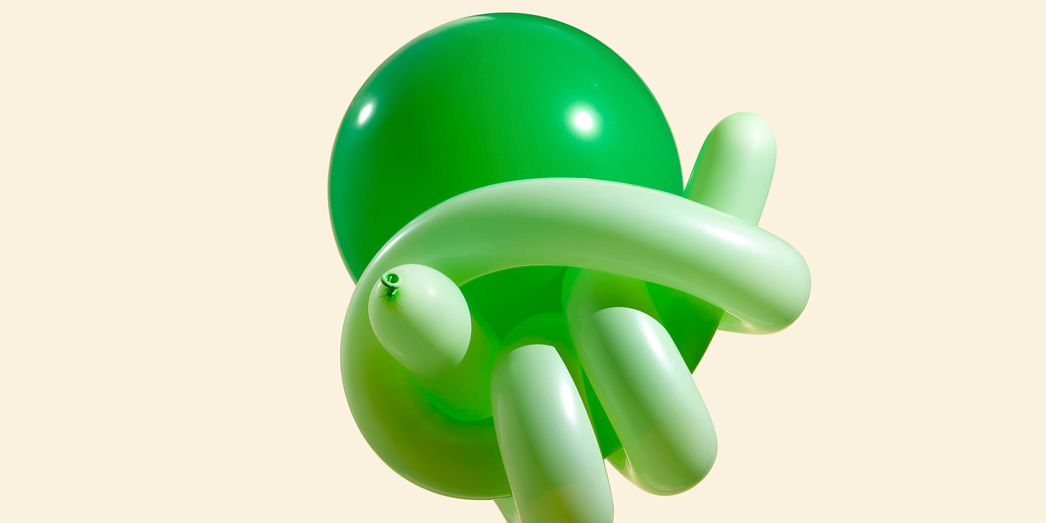 A cluster of green balloons in various shapes against a light background. A cluster of green balloons in various shapes against a light background.