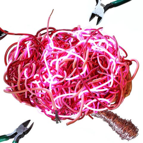 A tangled mass of colorful wires being cut by pliers, resembling a brain. A tangled mass of colorful wires being cut by pliers, resembling a brain.