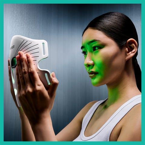 A woman using a light therapy mask designed for skincare treatments. A woman using a light therapy mask designed for skincare treatments.