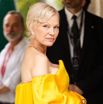 pamela anderson hepatitis c: pamela posing in a yellow dress