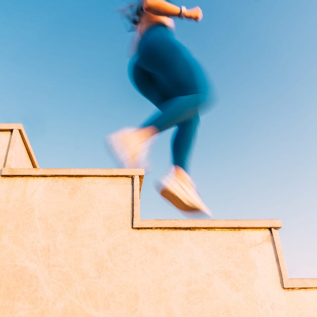 an abstract, motion blurred shot of a persons legs and feet running down a set of stairs the images dynamic feel captures the high energy and motion of a workout, symbolizing the relentless drive toward an active and healthy lifestyle