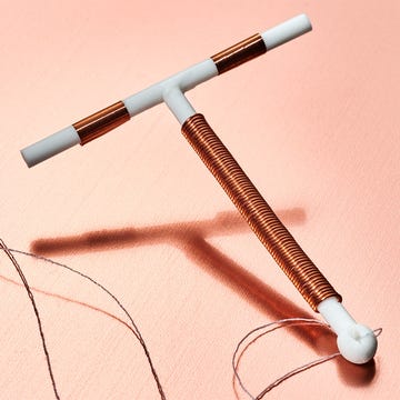 A threaded tool with a T-shaped handle on a pink background, used for sewing or crafting. A threaded tool with a T-shaped handle on a pink background, used for sewing or crafting.