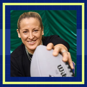 Person holding a football with a blurred face.
