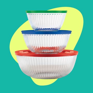stacked food storage bowls next to a container with coffee beans and a blender