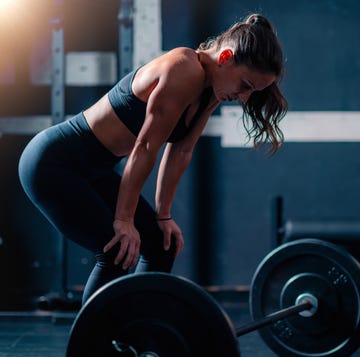 woman preparing for a weight training workout before lifting weights at the gym