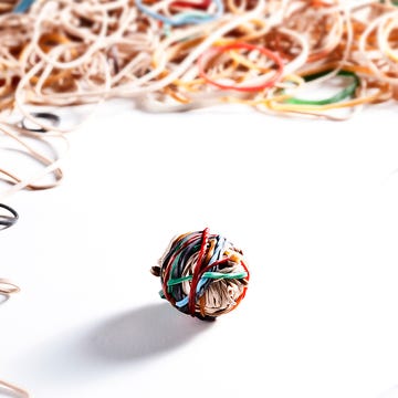 small elastic ball in the middle of many elastic bands,