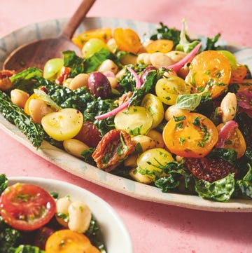 mixed bean and kale salad with colorful tomatoes served in a dish