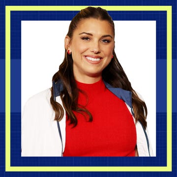Smiling person with long hair wearing a red top and white jacket, framed by a colorful border on a blue background.