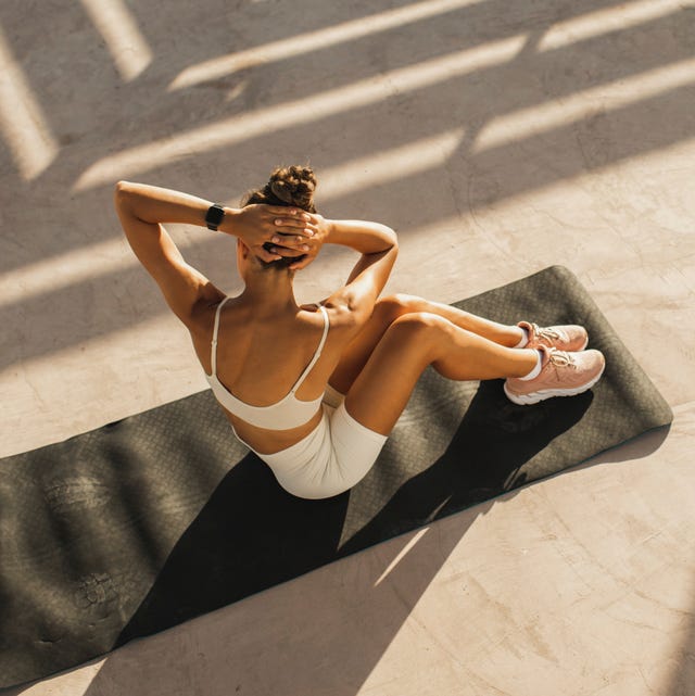ABS muscles endurance workout of young sportive woman. Powerful interval tabata training. woman doing sit ups