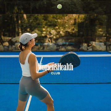 person playing padel on a blue court.