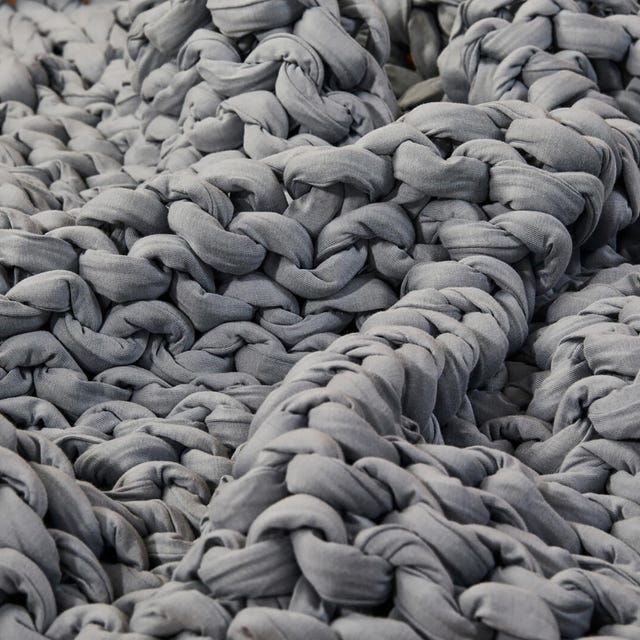 Textured gray fabric with a braided design, creating a cozy and warm appearance.