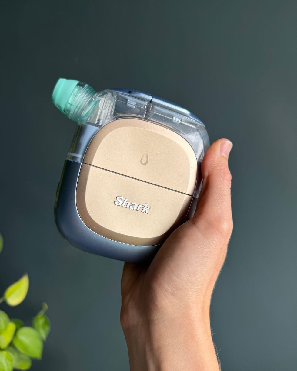 person holding a shark cleaning device with a water droplet icon. shark facialpro glow review