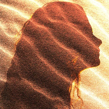Silhouette of a profile against a textured background with waves of color and light.