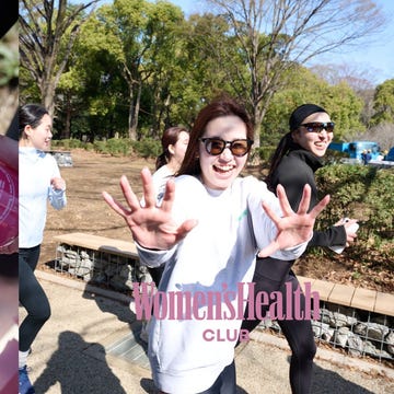 hands holding jars of pink juice and individuals in an outdoor setting