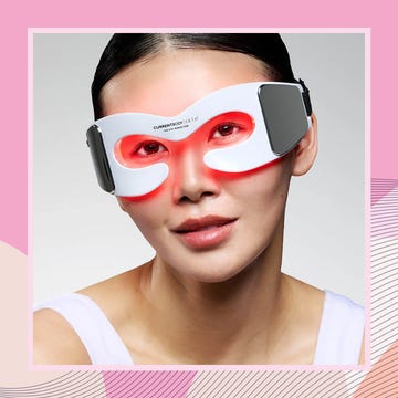 person wearing a led eye mask for skincare against a pink abstract background. best red light therapy eye masks