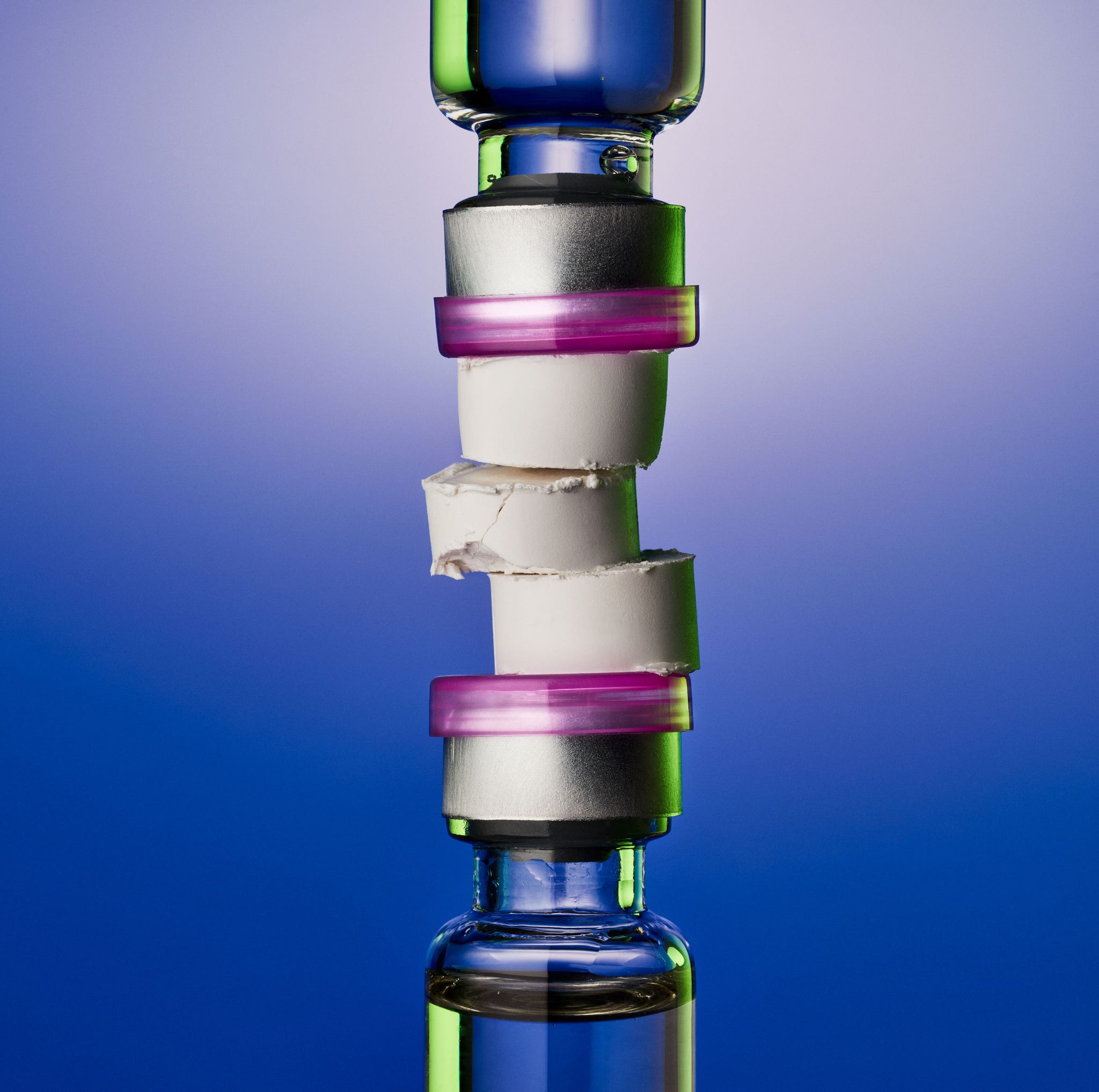 Stack of glass vials with colorful caps against a gradient background. Stack of glass vials with colorful caps against a gradient background.