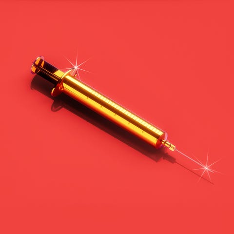 Golden syringe on a vibrant red background with sparkling highlights.