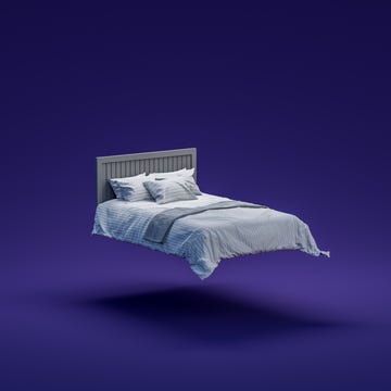 Large double bed with pillows mid air