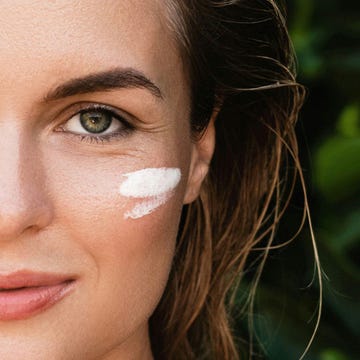 Woman with sun protection cream on her face. Woman with sun protection cream on her face.