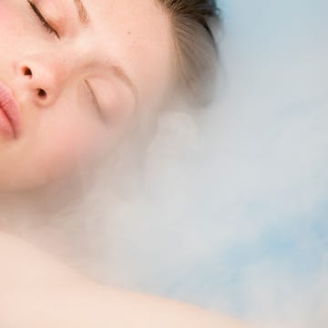 close up of young beautiful woman with eyes closed and steam