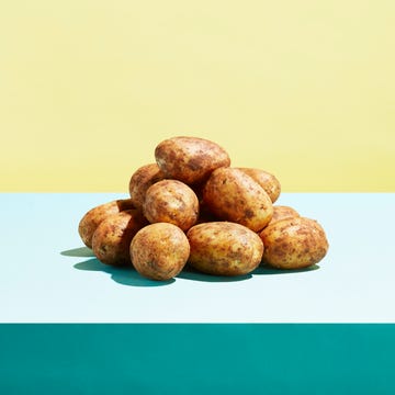 One potato alongside a heap of potatoes One potato alongside a heap of potatoes