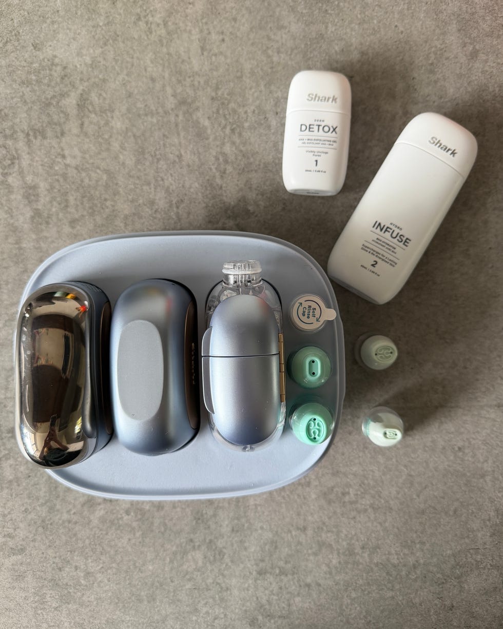 cleaning device with gray attachments and two white liquid containers. shark facialpro glow review