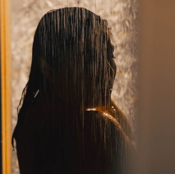 why ‘dark showering’ is trending as a nervous system reset: woman showering in the dark