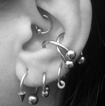 ear with many piercings ear with many piercings