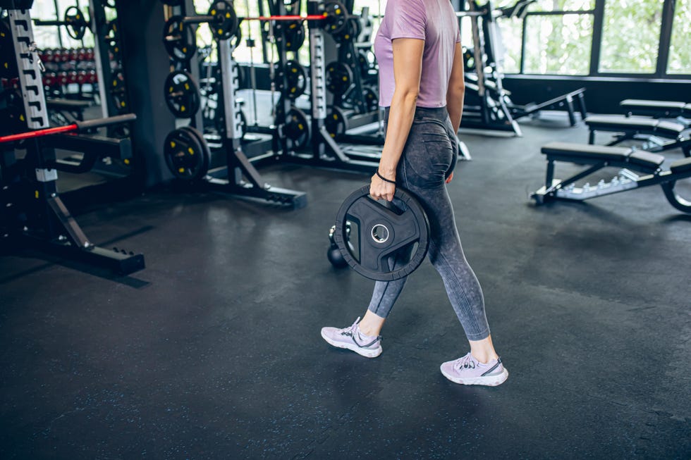 Young woman athlete preparing for weight lifting Young woman athlete preparing for weight lifting