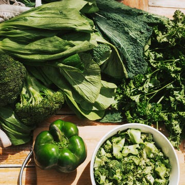 Fresh lettuce leaves, cayla, green pepper and broccoli on a wooden table. Farm greens and vegetables for cooking Fresh lettuce leaves, cayla, green pepper and broccoli on a wooden table. Farm greens and vegetables for cooking